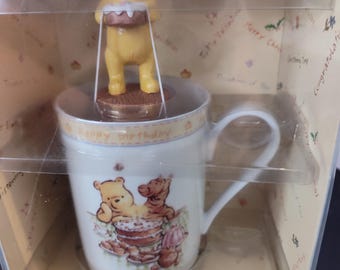 Royal Doulton Classic Winnie the Pooh Birthday Set. Consists of Mug and Figurine. 7" Tall 5 1/2" Across 3 3/4" Front to Back. New in Package