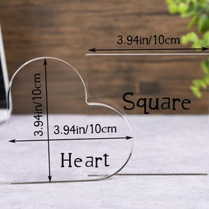 May include: Clear acrylic heart and square shapes, each measuring 3.94 inches (10cm) in width and height. The word "Heart" is below the heart shape, and "Square" is next to the square shape. Ideal for crafts or displays.