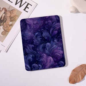 May include: A rectangular tablet case featuring a swirling, watercolor-style design in shades of deep purple and violet. The pattern includes stylized floral or foliate elements with a starry effect, creating a celestial or fantasy theme. The case has a smooth, glossy finish.