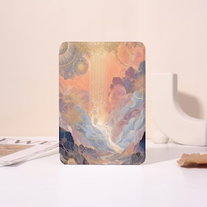 May include: A rectangular art print featuring a celestial landscape with clouds, mountains, and a beam of light. The artwork uses a palette of soft blues, pinks, and gold, creating a dreamy and ethereal feel. The print is displayed on a white surface.