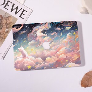 May include: Laptop case featuring a whimsical design of a white cat sitting on a cloud amidst a dreamy sky filled with stars, moons, and pastel-colored clouds. The Apple logo is visible. The case has a glossy finish.