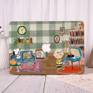 May include: Laptop skin featuring a cartoon interior scene with Snoopy and Woodstock on a blue couch, a record player, and Charlie Brown. The background has a green and white checkered pattern, a clock, and a bookshelf.