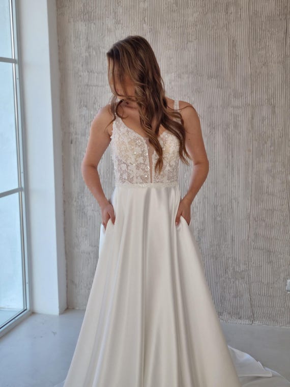 Plunge Neckline Satin Wedding Dress: A-Line Sleeveless Gown with Pockets