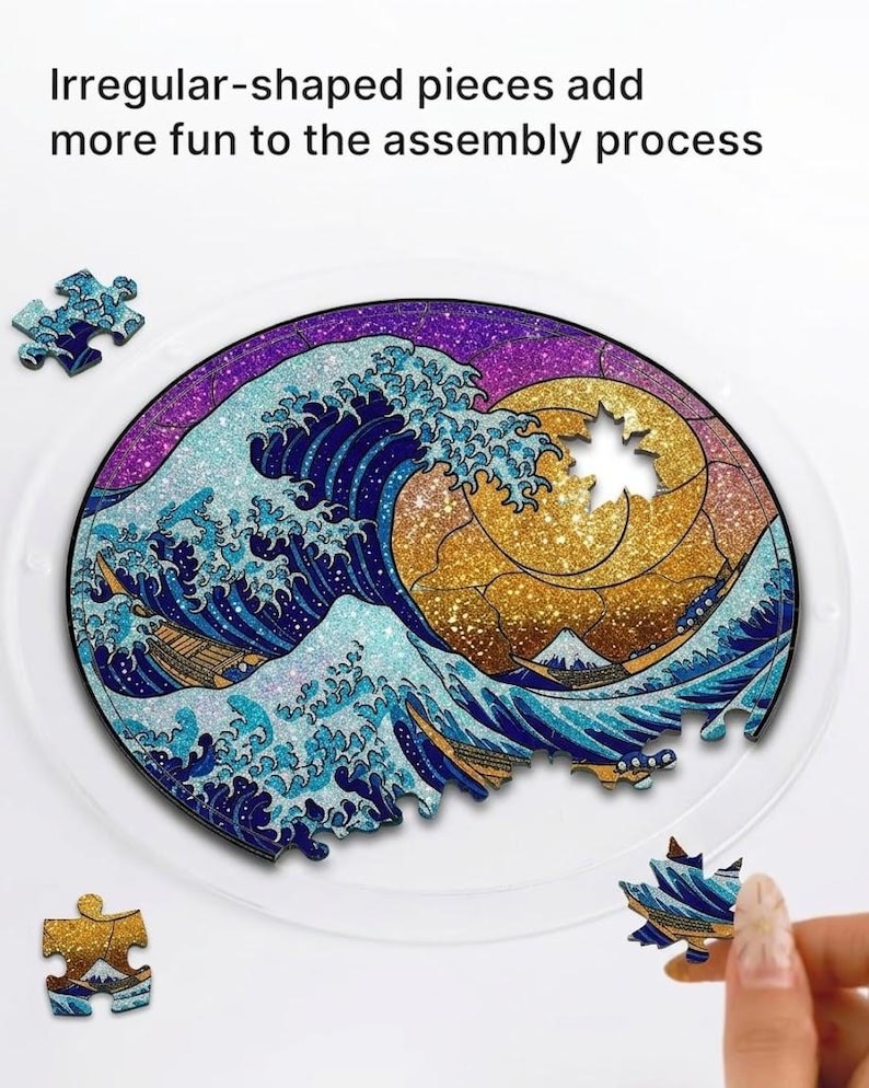 May include: A circular jigsaw puzzle depicting a stylized ocean wave design with a golden sun and a mountain. The puzzle has irregular-shaped pieces. The text "Irregular-shaped pieces add more fun to the assembly process" is visible.