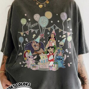 May include: Dark gray Comfort Colors t-shirt with a colorful graphic of characters from a popular animated movie celebrating a birthday. The design includes balloons, a cake, and the number 5. The word "Name" is also visible.