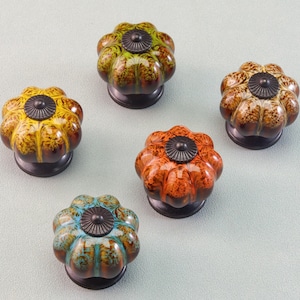 May include: A set of three ceramic mugs with a speckled, matte finish. The mugs are in shades of cream, light gray, and dark gray. Each mug has a simple, minimalist design, perfect for coffee or tea.