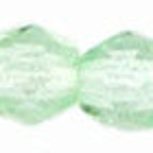 May include: A strand of light green glass beads with a faceted, oval shape.