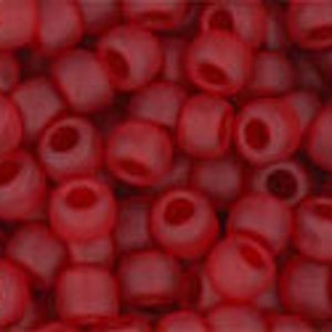 May include: A close-up image of a pile of small, round, red glass beads. The beads have a matte finish and are slightly translucent.
