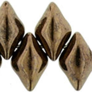 May include: A set of six bronze-colored faceted glass beads in a diamond shape. The beads are arranged in a row, with the points of the diamonds facing each other. There is also a single bronze-colored bead with two holes in the center.