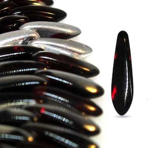 May include: A close-up of a strand of black and red glass beads. The beads are shaped like teardrops and have a glossy finish.