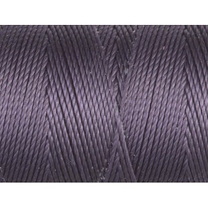 May include: Close-up of a spool of dark purple thread.