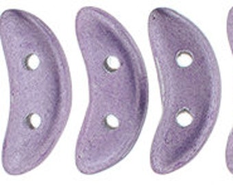May include: A collection of lavender-colored, crescent-shaped beads. Each bead has two holes for stringing. The beads have a textured, iridescent finish, and are suitable for jewelry making or craft projects.