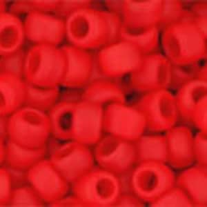 May include: A close-up view of a pile of small, red, round beads. The beads are made of glass and have a matte finish.