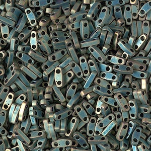 May include: A large pile of teal blue and gold two-hole seed beads. The beads are oval shaped and have a metallic finish.