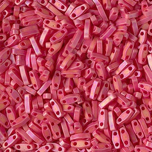 May include: A large pile of pink and orange iridescent glass beads. The beads are shaped like small rectangles with two holes in each bead.