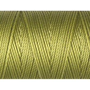 May include: A spool of green thread, perfect for sewing or crafting projects.