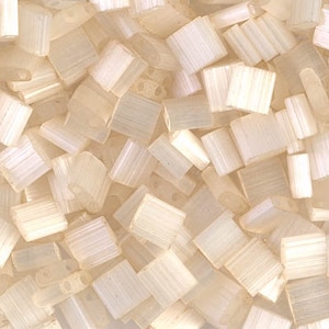 May include: A close-up of a pile of small, white, square beads. The beads have a slightly iridescent finish and are made of glass.