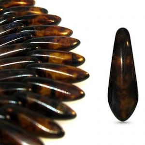 May include: A close-up of a single brown and black teardrop-shaped bead. The bead has a glossy finish and is made of glass or plastic.