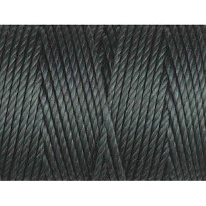May include: A spool of dark green thread.