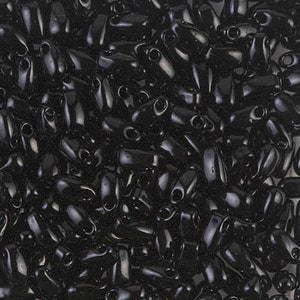 May include: A close-up view of a large quantity of black seed beads. The beads are small and have a glossy finish.