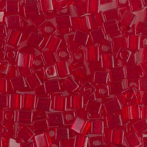 May include: A close-up of a pile of red square beads. The beads are made of glass and have a shiny finish.
