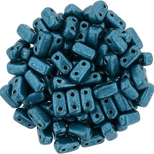 May include: A large pile of teal blue glass beads with two holes in each bead. The beads are rectangular in shape and have a metallic finish.