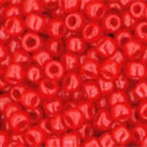 May include: A close-up image of a large quantity of small, red, round seed beads. The beads are shiny and have a smooth, glossy finish.
