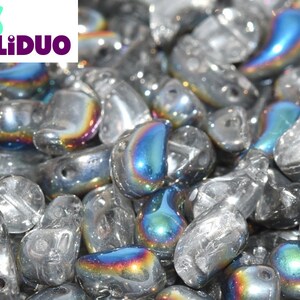 May include: A close-up of iridescent glass beads in a teardrop shape. The beads are clear with a rainbow sheen.