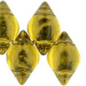May include: Six gold-colored glass beads with a faceted, teardrop shape. The beads are arranged in a row, with the points of the teardrops facing each other. A single, smaller, gold-colored glass bead with two holes is shown to the right of the larger beads.