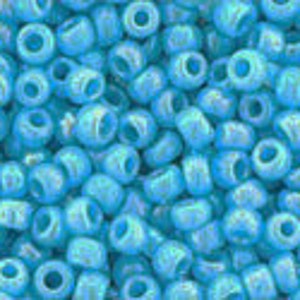 May include: A close-up of a large quantity of small, round, light blue glass beads. The beads have a slightly iridescent finish.