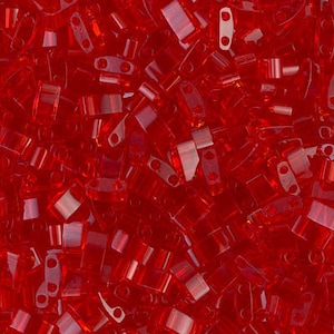 May include: A close-up shot showcases a vibrant collection of small, rectangular, transparent red beads. Each bead has two holes, and they are scattered, creating a textured, eye-catching surface. These beads are ideal for jewelry making and crafting.