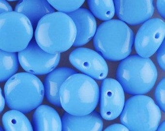 May include: A close-up shot displays a collection of light blue, irregularly shaped beads. Each bead has a glossy finish and a small hole for stringing. The beads vary in size and are scattered across the frame.
