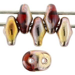 May include: Six iridescent glass beads in shades of gold, pink, and red. The beads are oval shaped with a slight twist and have a metallic sheen.