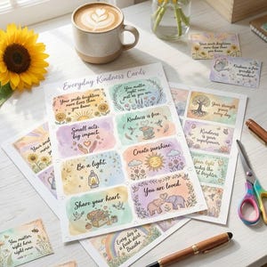 May include: A collection of "Everyday Kindness Cards" with watercolor illustrations and inspirational quotes, alongside a cup of coffee, sunflowers, and stationery. The cards feature phrases like "You matter, right here, right now."