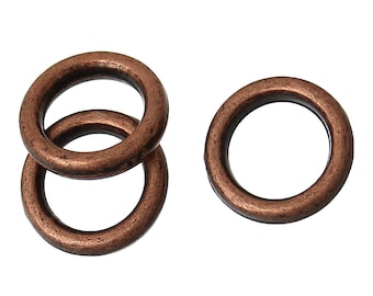 May include: Three copper jump rings, two stacked on top of each other, and one separate ring.