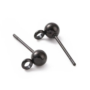 May include: Two black metal earring posts with a small loop at the top and a round ball at the bottom.