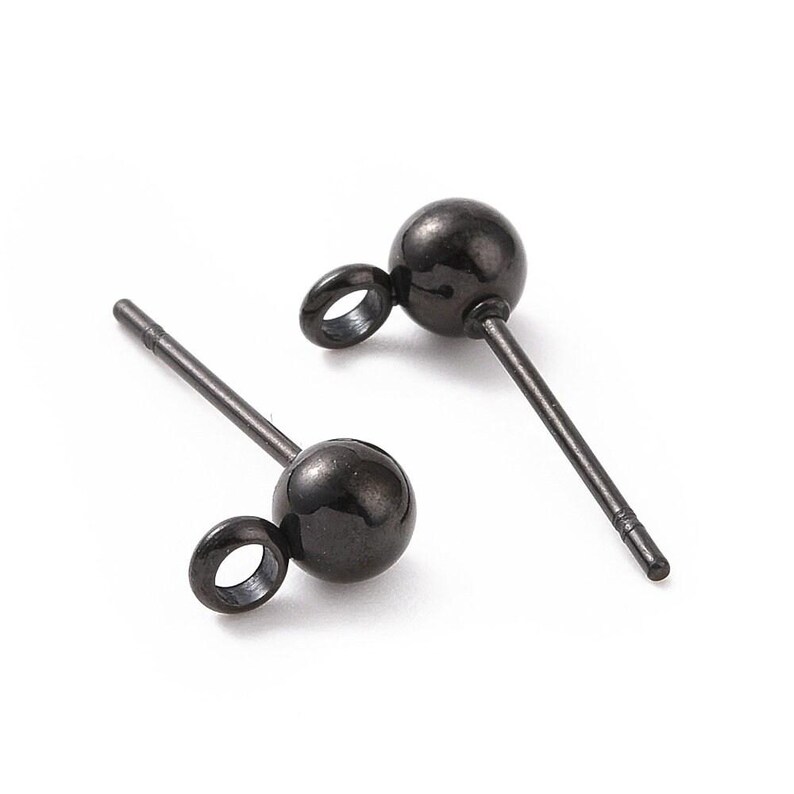 May include: Two black metal earring posts with a small loop at the top and a round ball at the bottom.