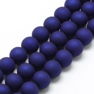 May include: A strand of matte blue round beads. The beads are smooth and have a slightly iridescent finish.