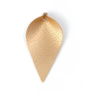 May include: A gold teardrop-shaped leather earring with a wire loop at the top.