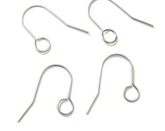 May include: Four silver-colored earring hooks are displayed against a white background. Each hook has a curved top, a small loop, and a straight, pointed end. The hooks are designed for jewelry making and crafting.