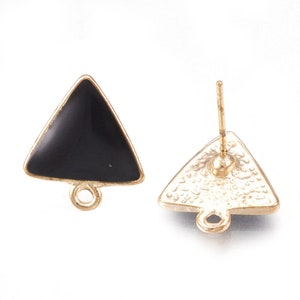 May include: A pair of gold-tone triangle shaped earring studs with black enamel. The earrings have a loop on the bottom for attaching a charm or pendant.