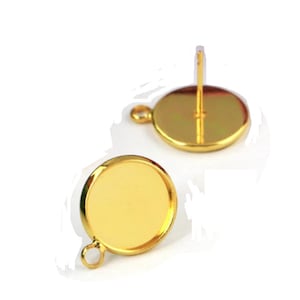 May include: Two gold-toned round earring blanks with a loop on one side and a post on the other side.
