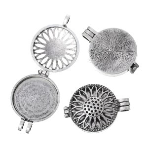 May include: Four silver locket pendants with different designs. Each locket has a hinged lid and a loop for attaching a chain. The lockets are in various styles, including a sunburst, a sunflower, and a plain design.