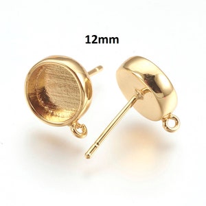 May include: A pair of gold-tone earring settings with a 12mm round bezel and a jump ring. The earring posts are made of metal and have a loop at the top.