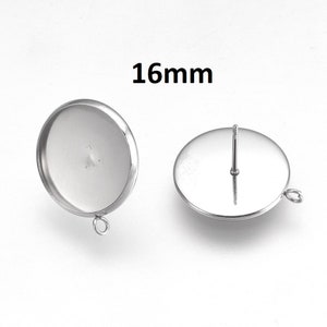 May include: Two silver earring settings with a 16mm diameter. One setting has a post and the other has a loop.