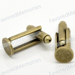 May include: A pair of antique gold cufflinks. The cufflinks are made of metal and have a simple design.