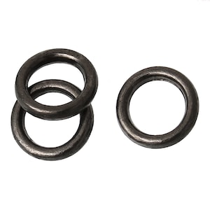 May include: Three black metal rings, two stacked on top of each other, and one separate.