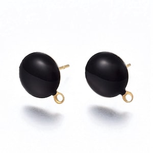 May include: A pair of black round earring studs with gold-toned posts and loops. The earrings are made of metal and have a smooth, glossy finish.