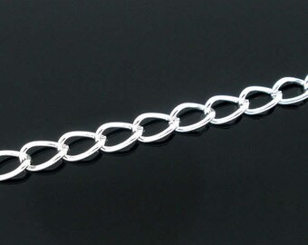 May include: A silver chain with oval links. The chain is on a black background.
