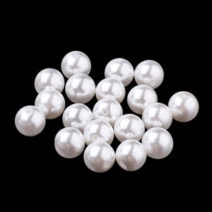 May include: A pile of white pearl beads, perfect for crafting jewelry or adding a touch of elegance to any project.